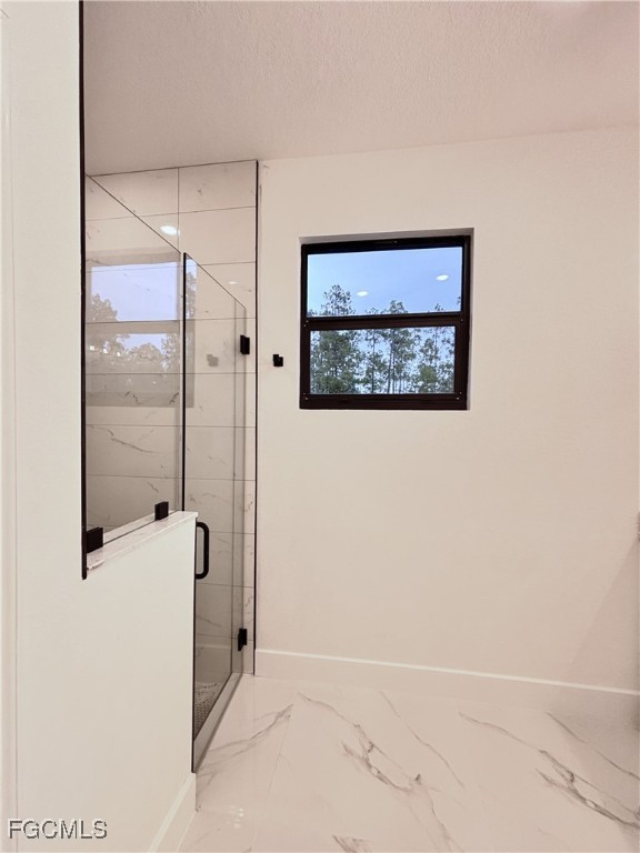 113 Monroe Avenue Lehigh Acres, FL 33936 - Photo 14 of 24 a view of a hallway with paintings on the wall