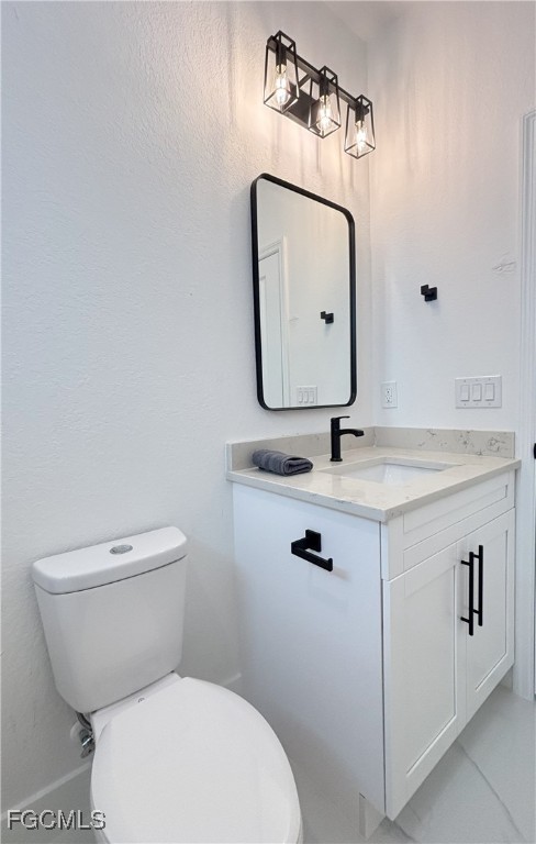 113 Monroe Avenue Lehigh Acres, FL 33936 - Photo 17 of 24 a bathroom with a toilet sink and mirror