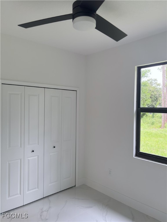 113 Monroe Avenue Lehigh Acres, FL 33936 - Photo 7 of 24 a view of an empty room with a window