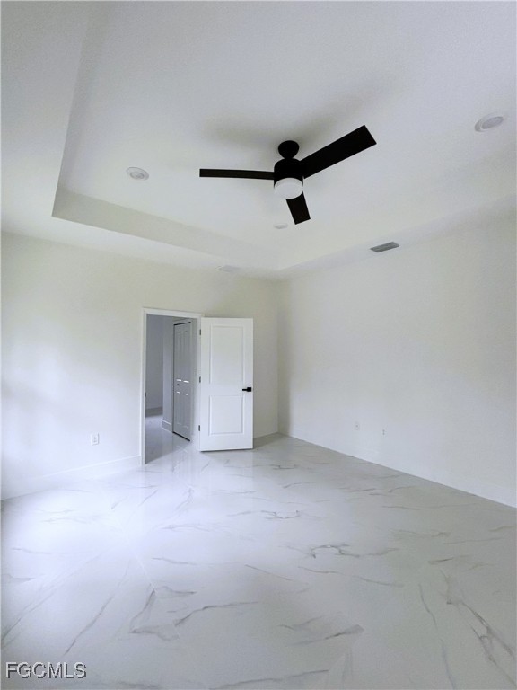 113 Monroe Avenue Lehigh Acres, FL 33936 - Photo 9 of 24 an empty room with a ceiling fan and window
