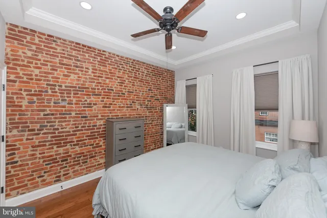 a bedroom with a bed and a ceiling fan