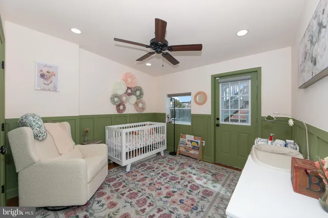 a bedroom with a baby crib and a window
