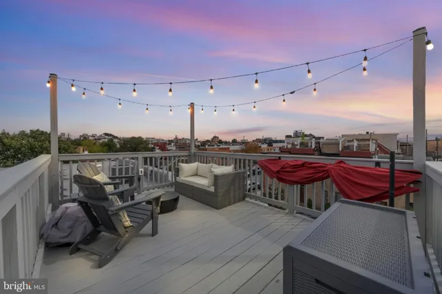 a view of a balcony with chairs and wooden floor