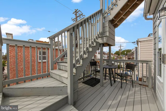 a view of a balcony with a table and chairs