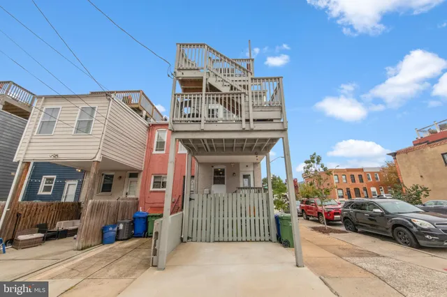 a front view of a house with sitting area