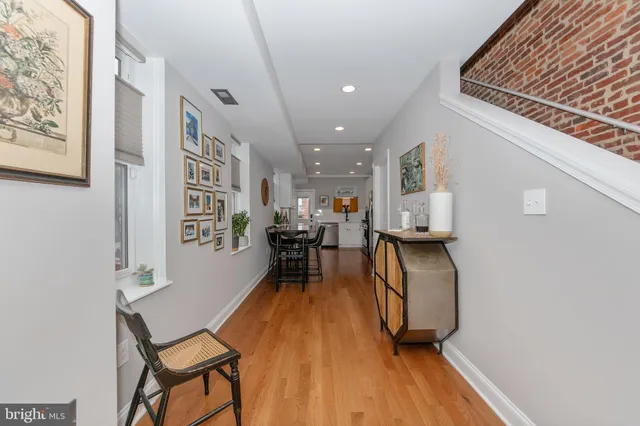 a view of a room with furniture and wooden floor