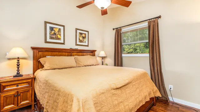 a large bed sitting in a bedroom next to a window