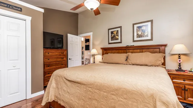 a bedroom with a bed and a flat screen tv