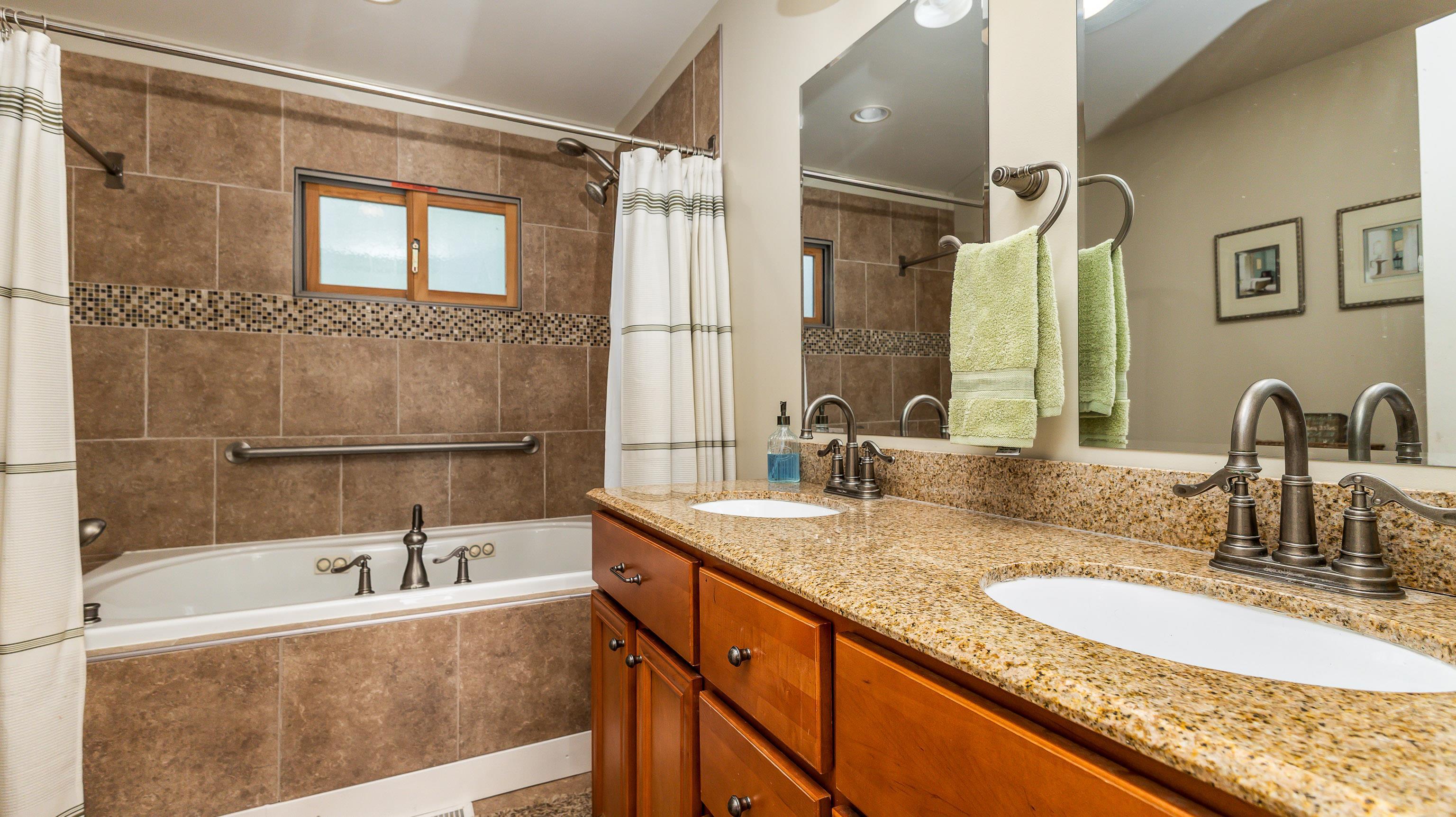 2 Sunbow Path Galena, IL 61036 - Photo 23 of 37 a bathroom with a granite countertop tub sink and mirror