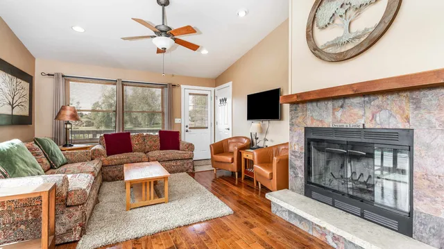 a living room with furniture a fireplace and a flat screen tv