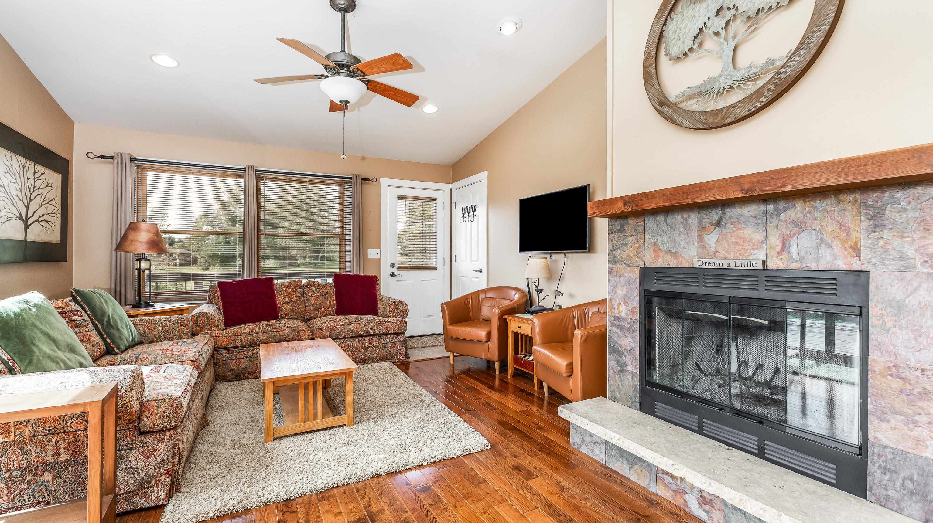 2 Sunbow Path Galena, IL 61036 - Photo 5 of 37 a living room with furniture a fireplace and a flat screen tv