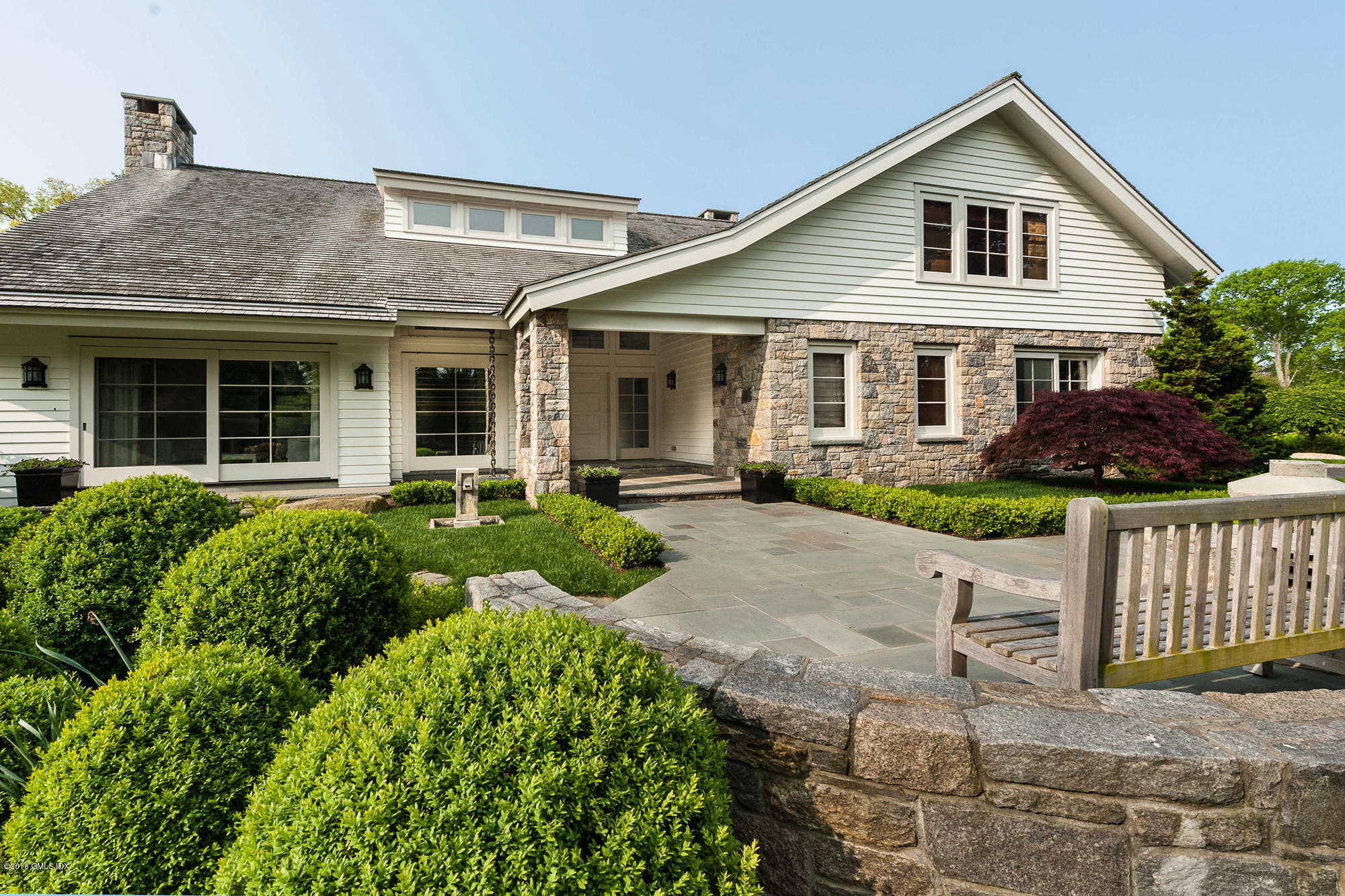2 Seagate Road Riverside, CT 06878 - Photo 32 of 38 a front view of a house with a yard and potted plants