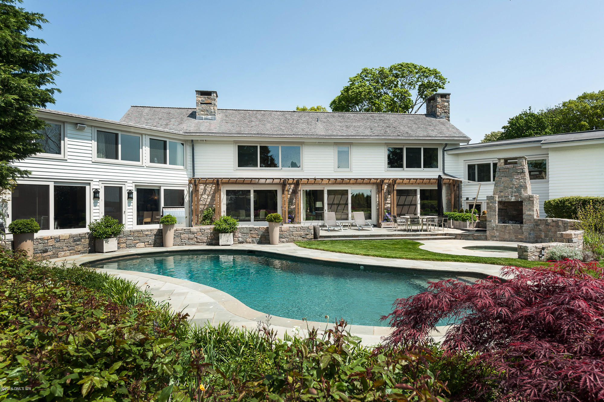 2 Seagate Road Riverside, CT 06878 - Photo 10 of 38 a front view of a house with swimming pool having outdoor seating
