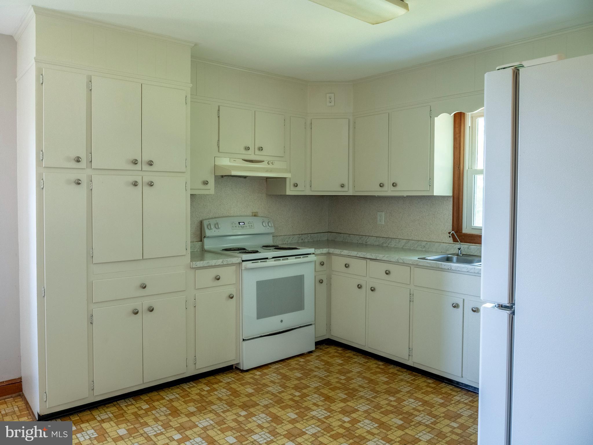 26906 Clarksburg Road Damascus, MD 20872 - Photo 7 of 17 a kitchen with granite countertop white cabinets and sink