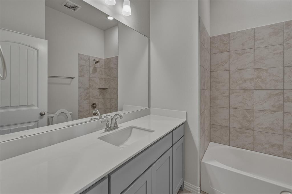 136 Hillview Trail Decatur, TX 76234 - Photo 21 of 26 Single vanity with an integrated sink and light grey cabinetry