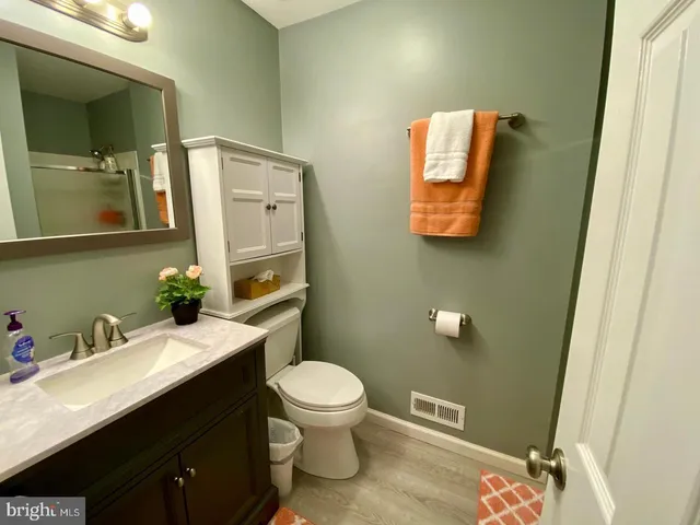 a bathroom with a toilet sink and mirror
