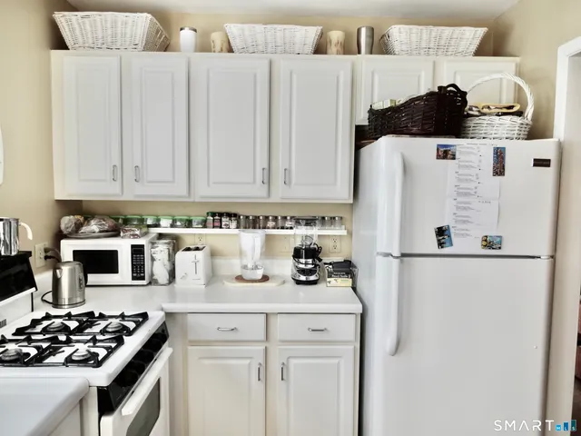 a white refrigerator freezer sitting inside of a kitchen
