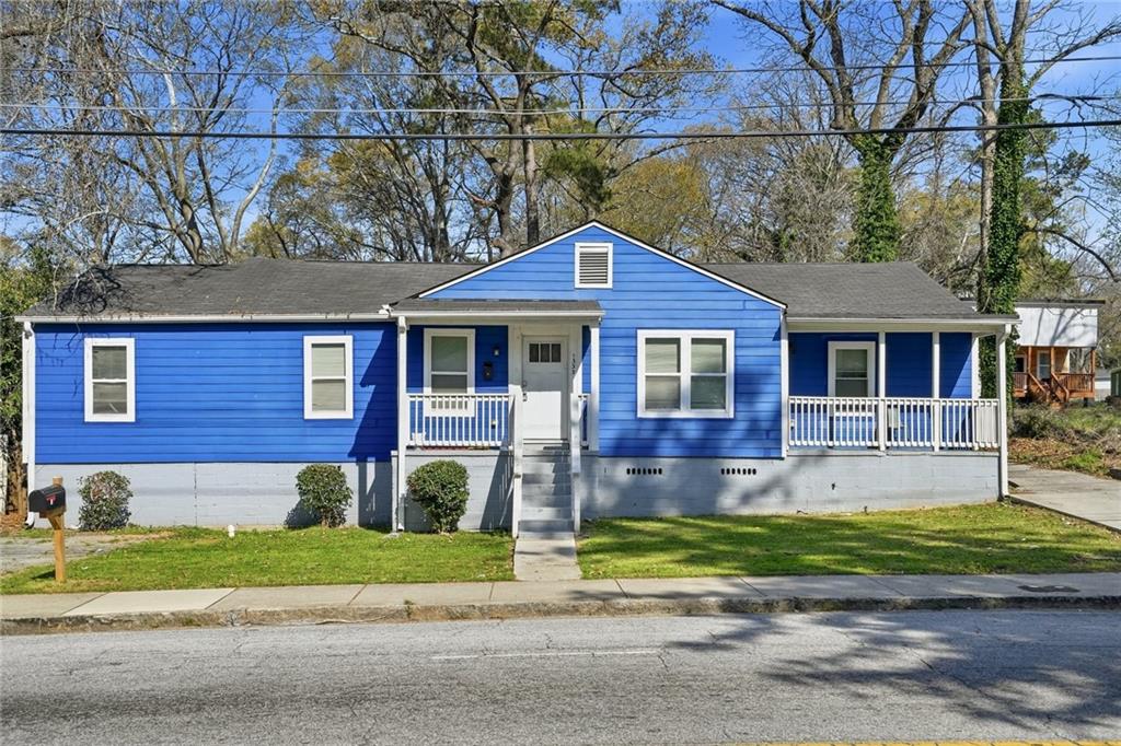 1333 Campbellton Road Southwest Atlanta, GA 30310 - Photo 2 of 21 a front view of a house with a yard
