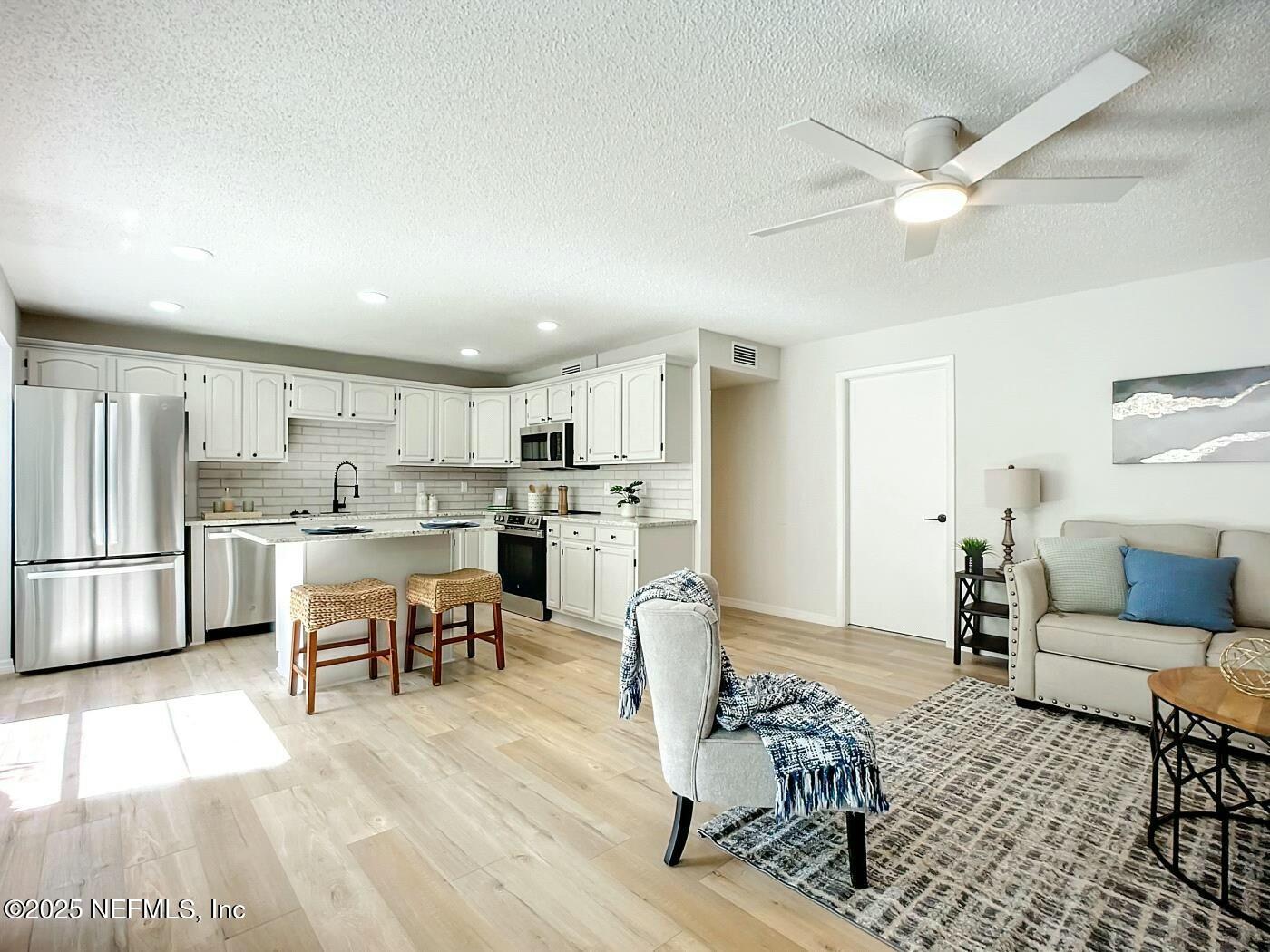 8735 Moss Haven Road Jacksonville, FL 32221 - Photo 11 of 29 a living room with furniture and kitchen view