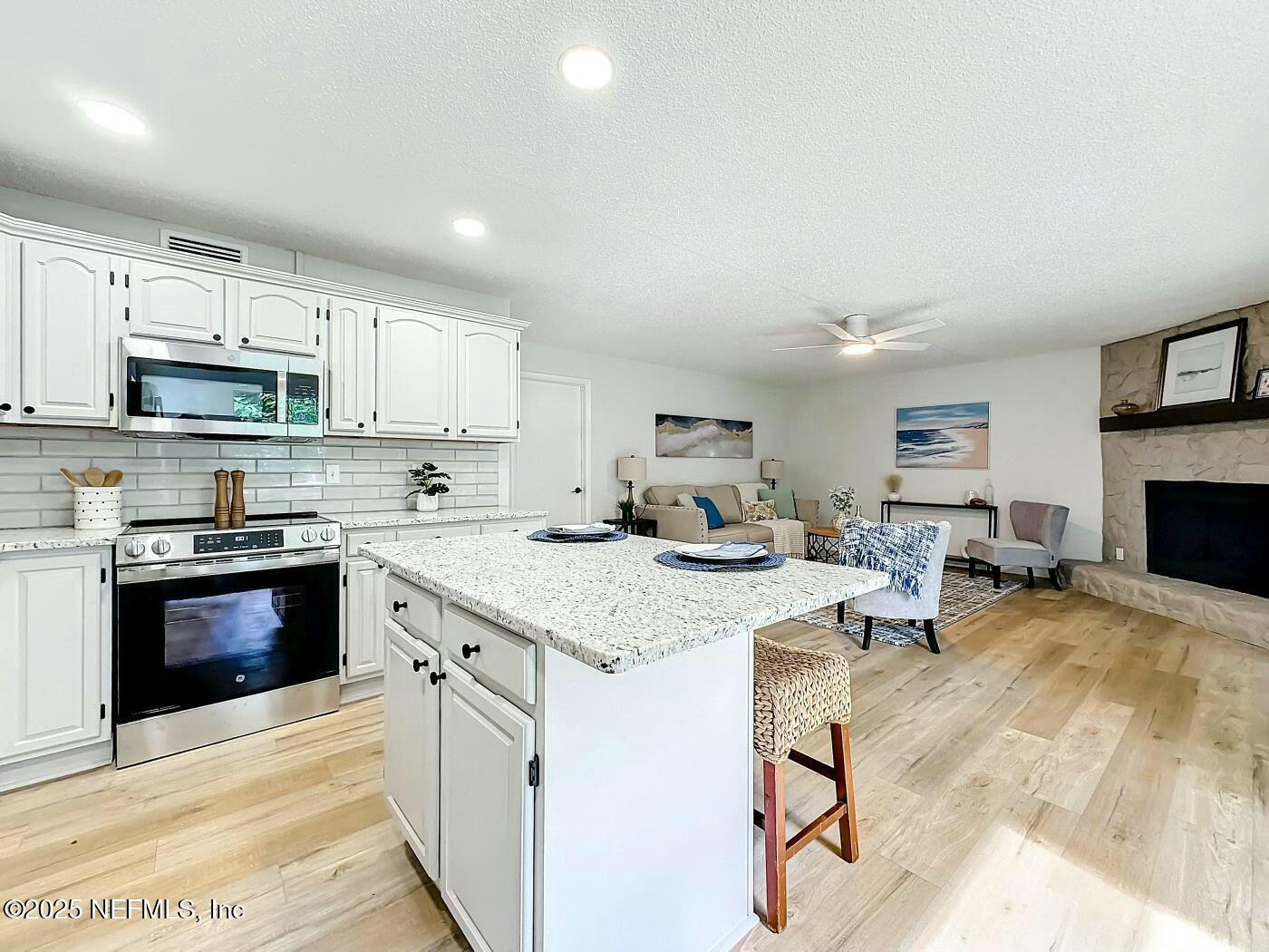 8735 Moss Haven Road Jacksonville, FL 32221 - Photo 12 of 29 a kitchen with counter top space cabinets and appliances