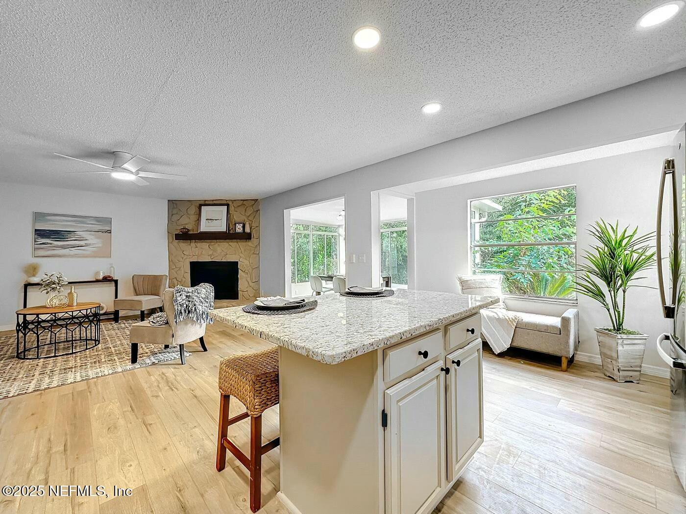 8735 Moss Haven Road Jacksonville, FL 32221 - Photo 13 of 29 a living room with furniture a fireplace and a table