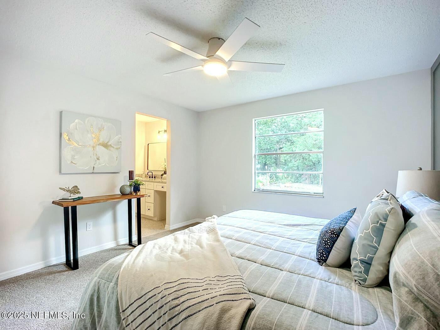 8735 Moss Haven Road Jacksonville, FL 32221 - Photo 17 of 29 a bedroom with a bed and a chair