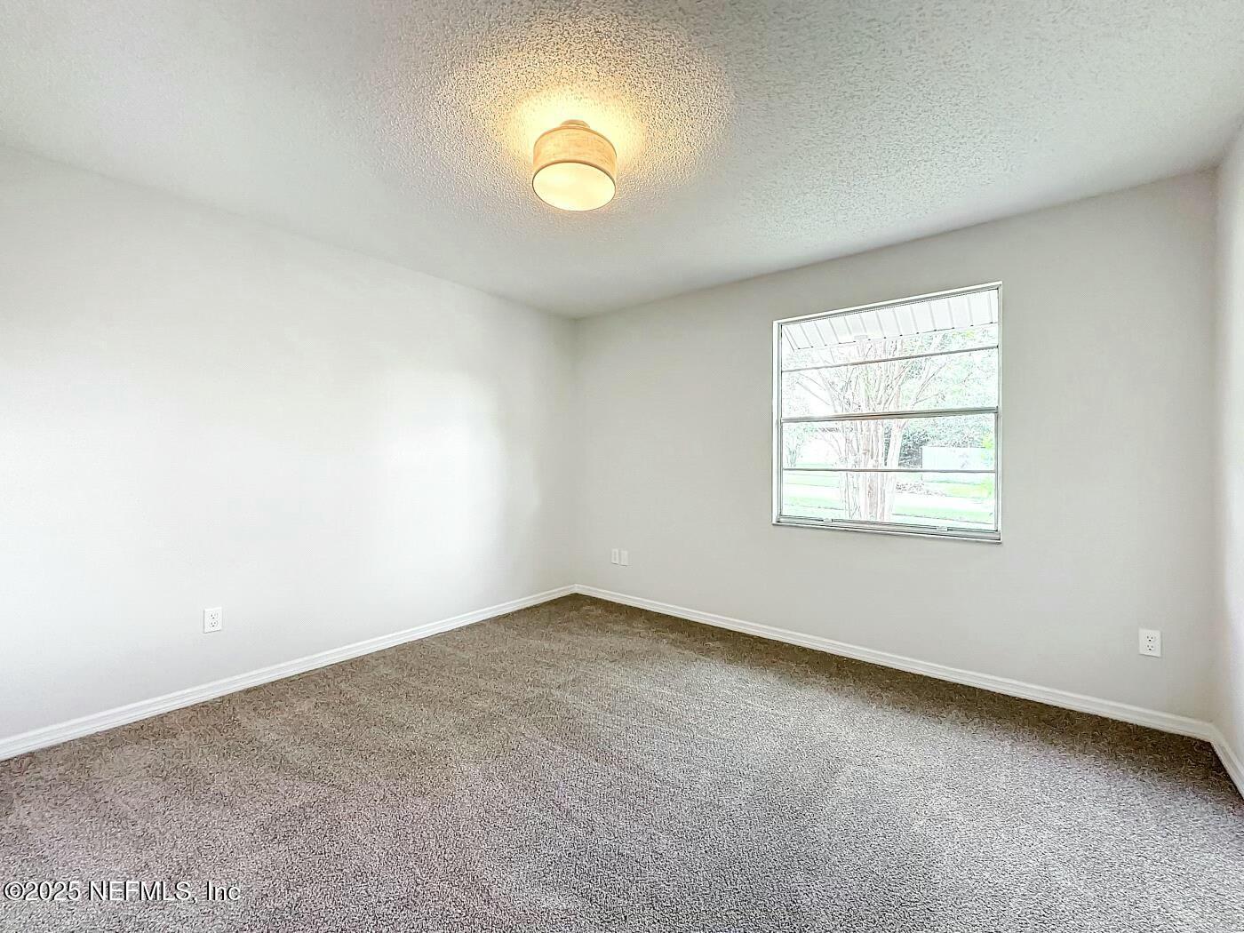 8735 Moss Haven Road Jacksonville, FL 32221 - Photo 21 of 29 an empty room with a window