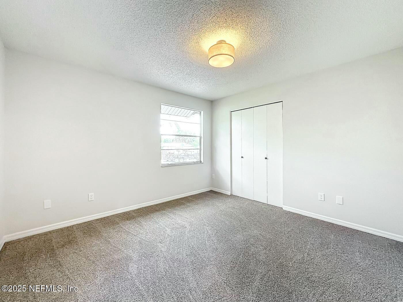 8735 Moss Haven Road Jacksonville, FL 32221 - Photo 22 of 29 an empty room with windows