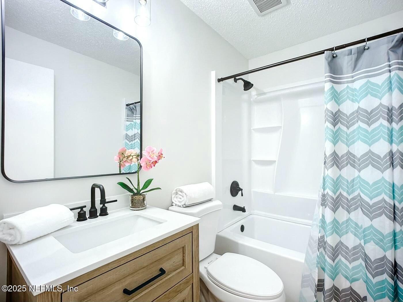 8735 Moss Haven Road Jacksonville, FL 32221 - Photo 5 of 29 a bathroom with a sink toilet a mirror and shower