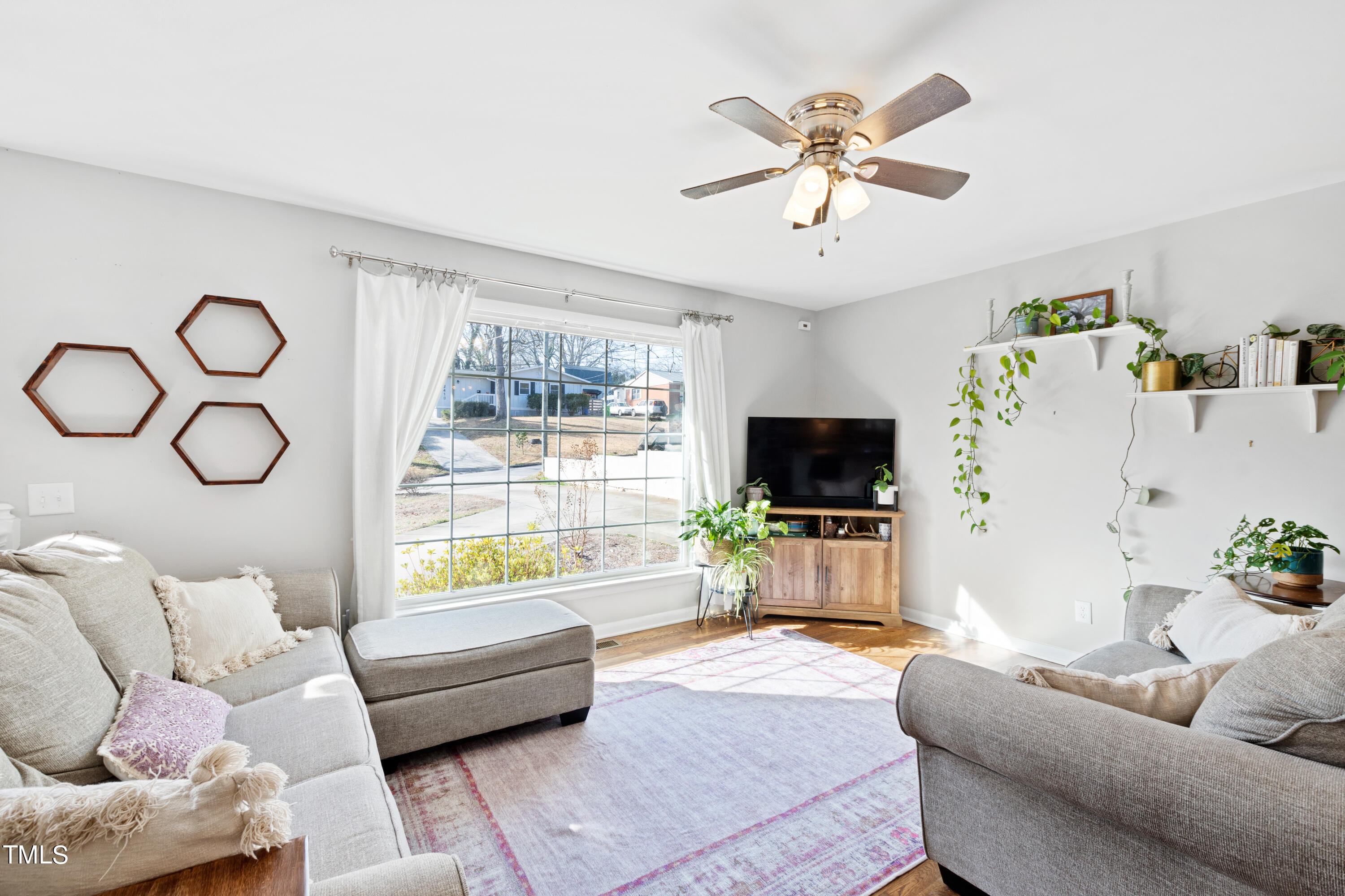 2413 Kennington Road Raleigh, NC 27610 - Photo 12 of 33 a living room with furniture and a flat screen tv