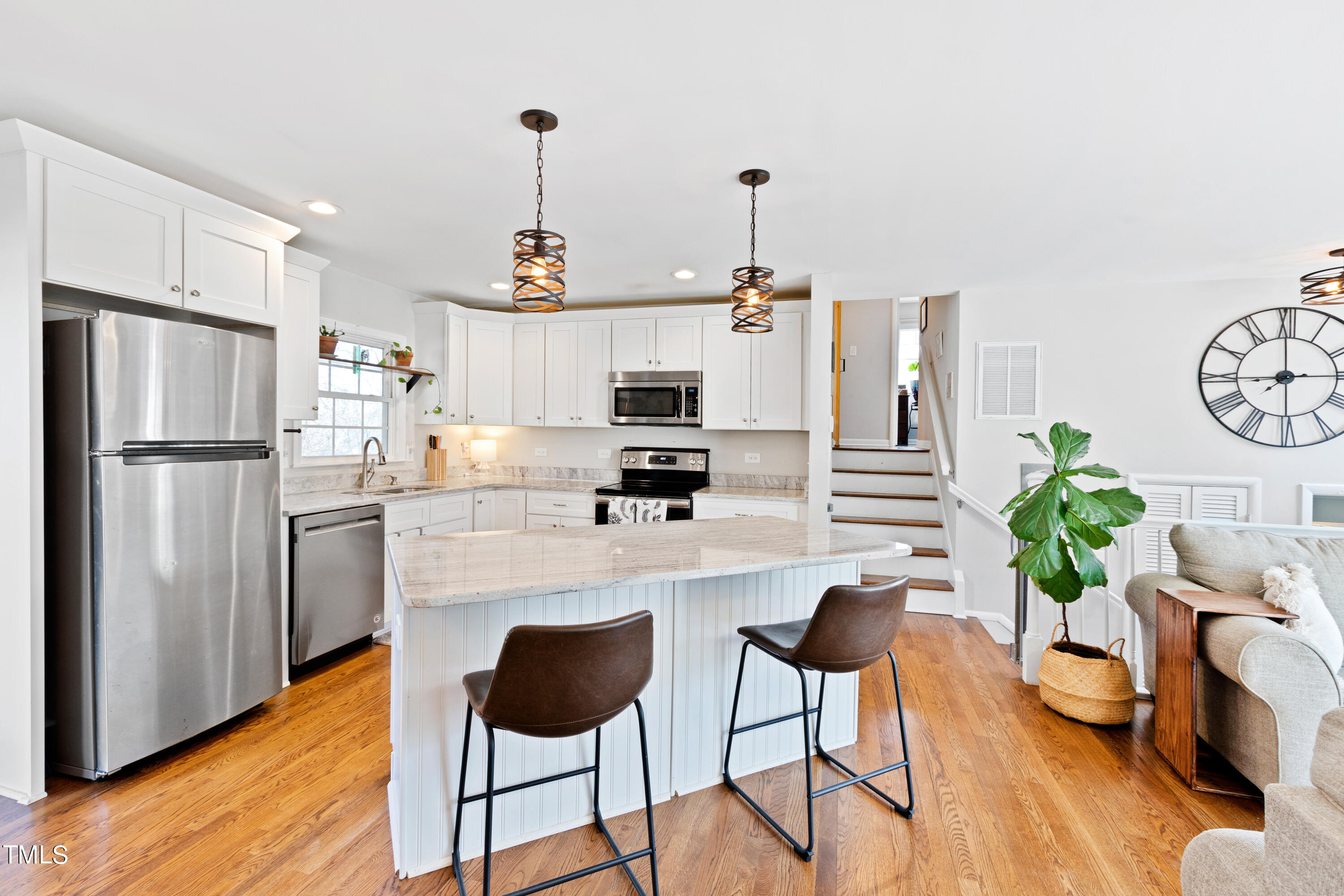 2413 Kennington Road Raleigh, NC 27610 - Photo 15 of 33 a kitchen with stainless steel appliances granite countertop a refrigerator a stove a sink dishwasher and white cabinets with wooden floor