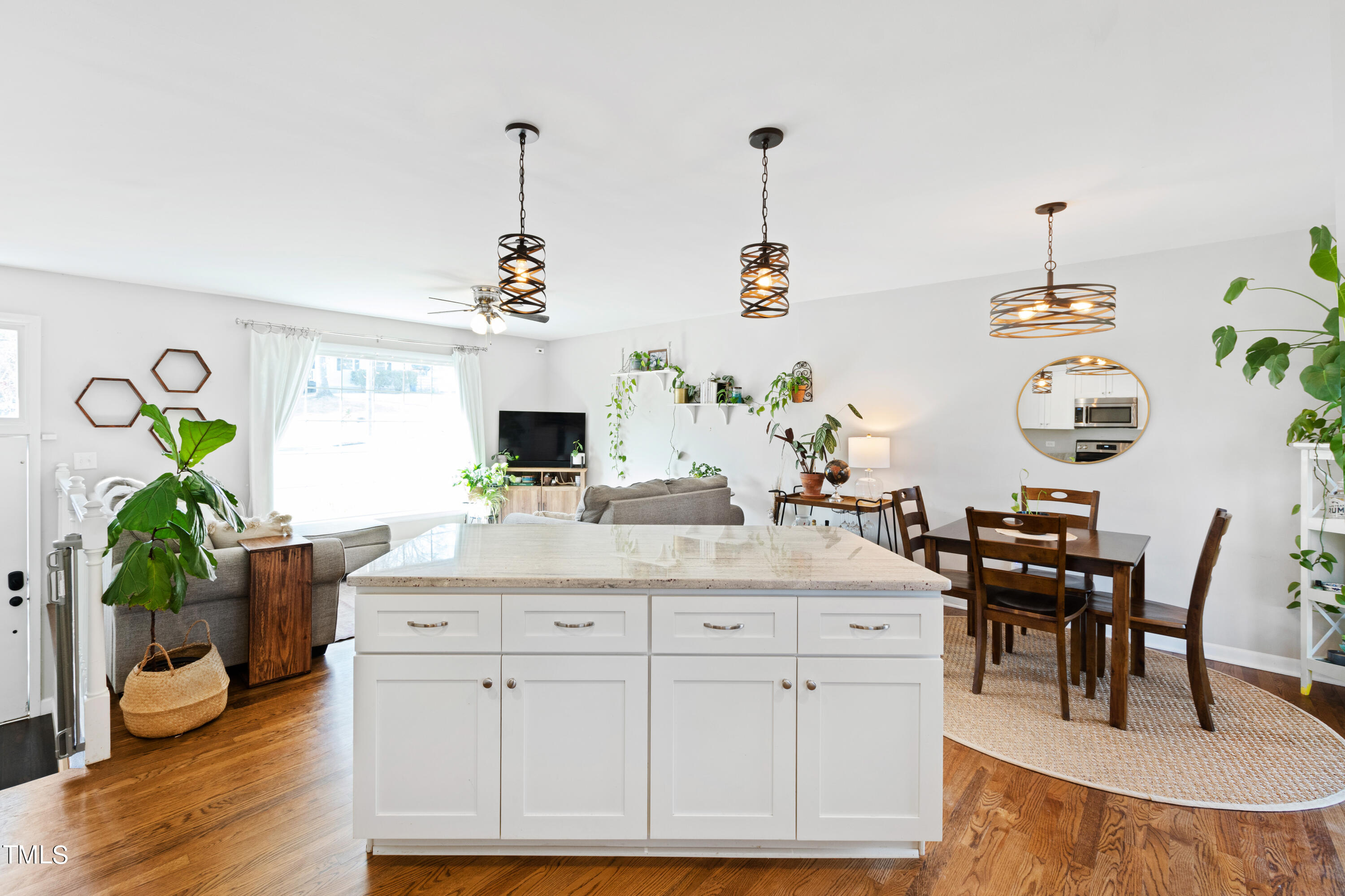 2413 Kennington Road Raleigh, NC 27610 - Photo 16 of 33 a dining hall with stainless steel appliances kitchen island granite countertop a table and chairs in it