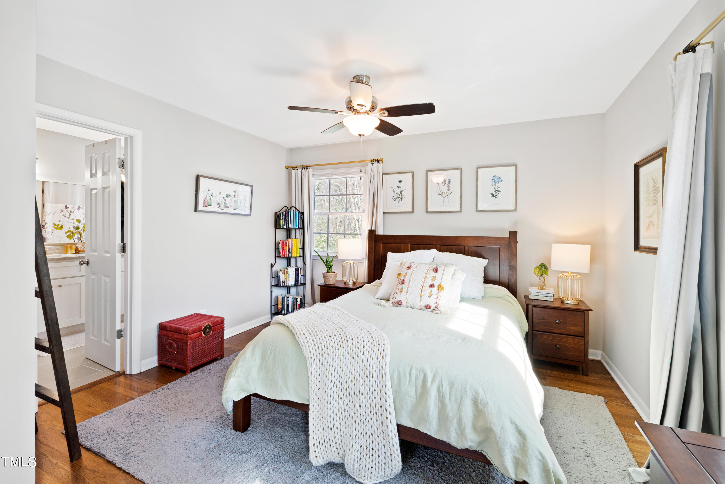 2413 Kennington Road Raleigh, NC 27610 - Photo 19 of 33 a bedroom with a bed and a chandelier