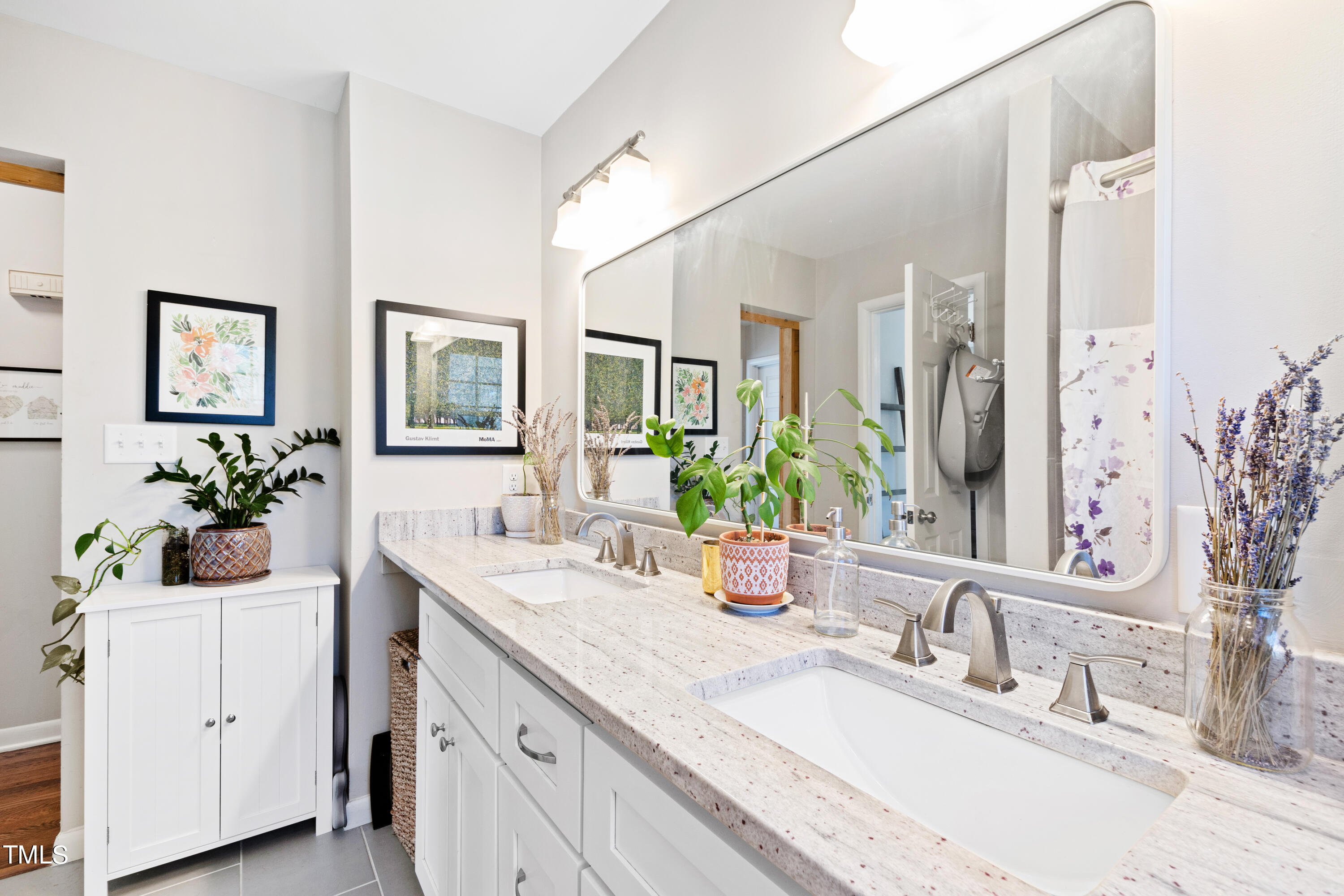 2413 Kennington Road Raleigh, NC 27610 - Photo 21 of 33 a bathroom with double vanity sinks a vanity and a mirror