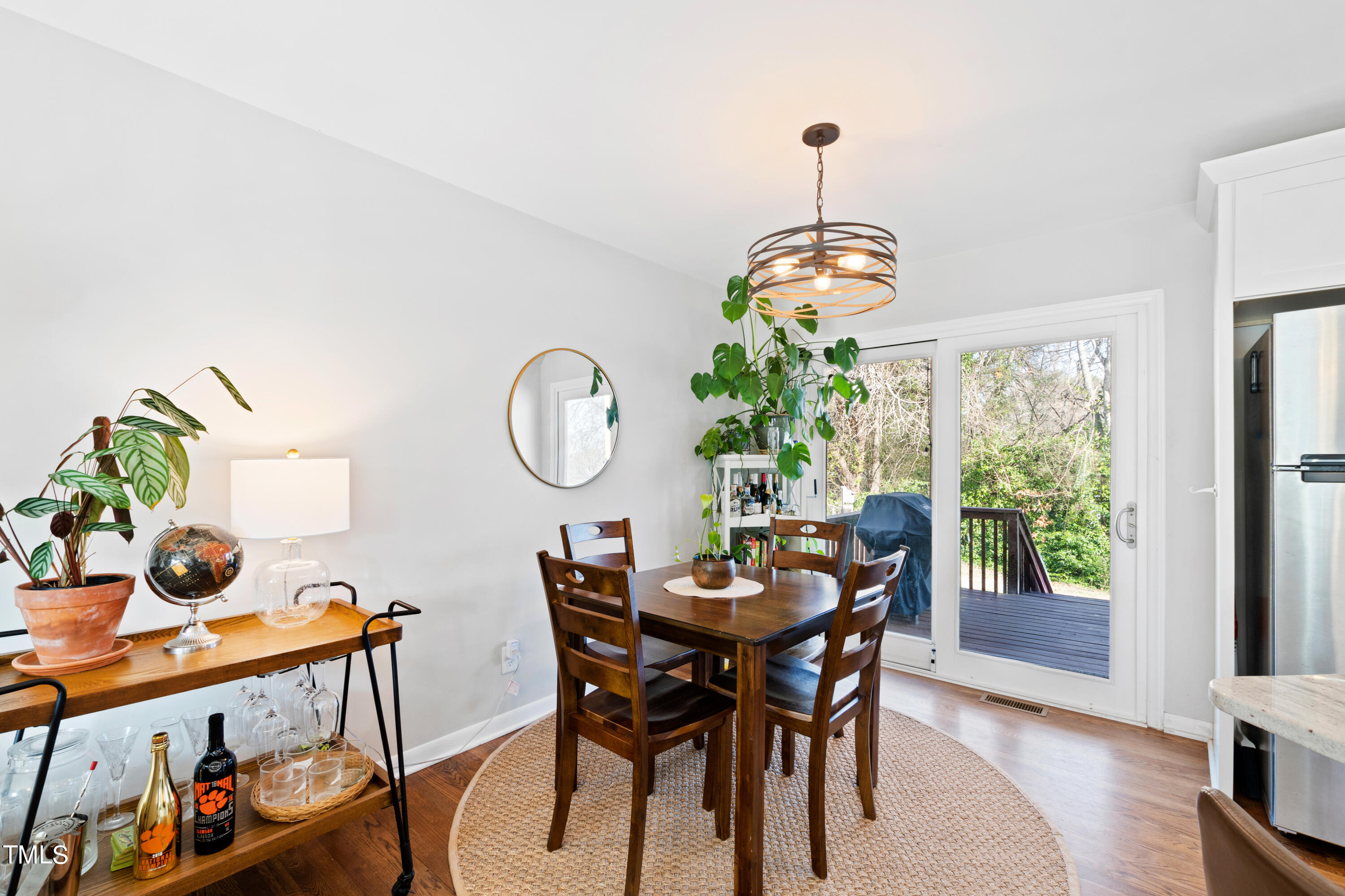 2413 Kennington Road Raleigh, NC 27610 - Photo 4 of 33 a dining room with furniture a window and a chandelier