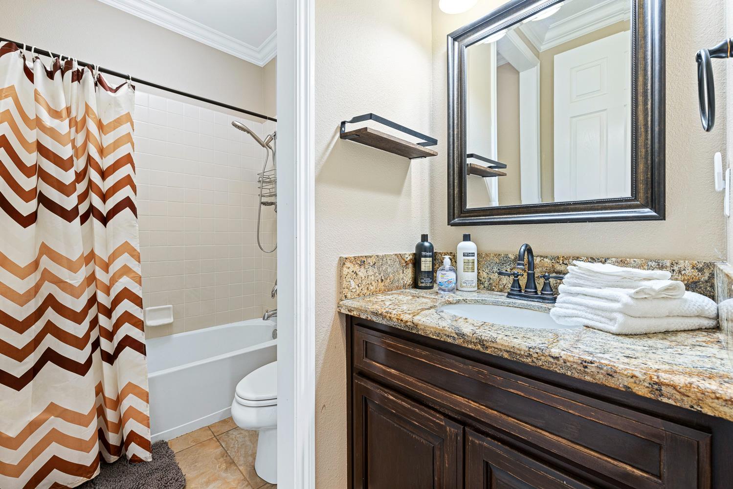 3133 Everglade Avenue Clovis, CA 93619 - Photo 12 of 33 a bathroom with a granite countertop sink toilet and shower