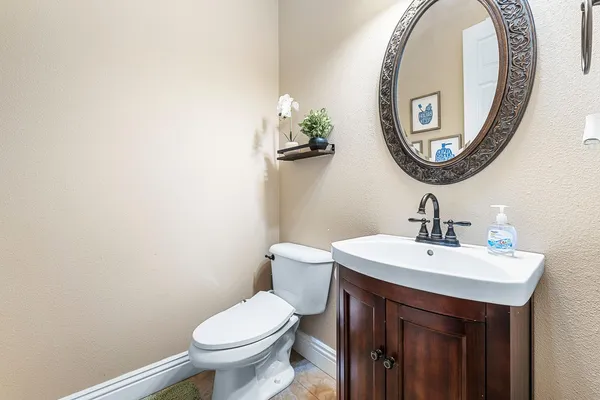 a bathroom with a toilet a sink and a mirror