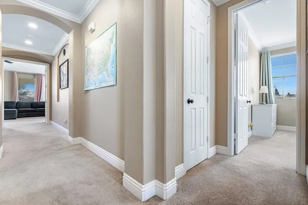 a view of a hallway with furniture and a livingroom view