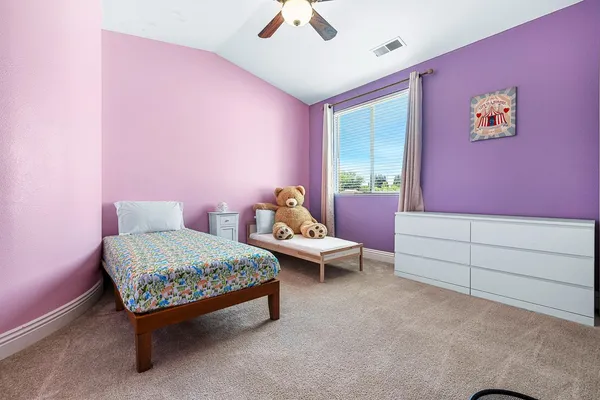 a bed room with a bed and a chandelier