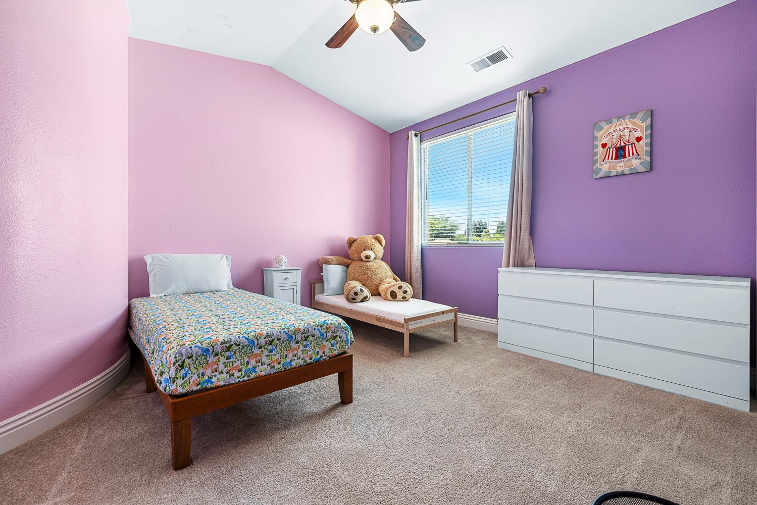 3133 Everglade Avenue Clovis, CA 93619 - Photo 19 of 33 a bed room with a bed and a chandelier