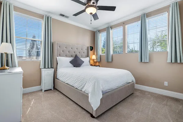 a bedroom with a large bed and a chandelier