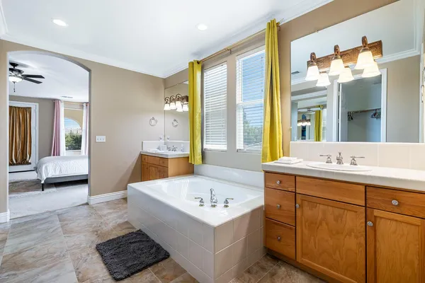 a bathroom with a sink a large mirror and a bathtub