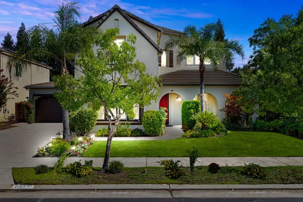 a front view of a house with a yard
