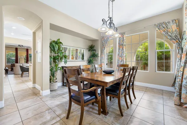 a view of a dining room with furniture wooden floor and chandelier