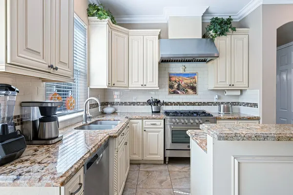 a kitchen with a stove sink and cabinets