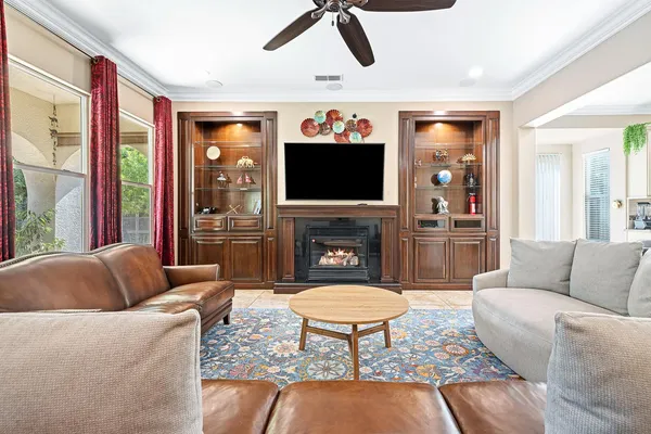 a living room with furniture a flat screen tv and a fireplace
