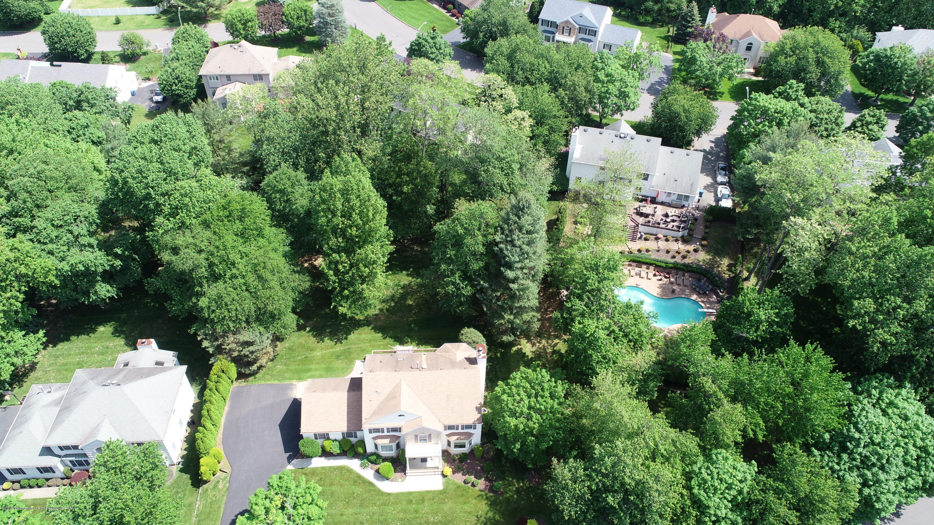 259 Nottingham Road Morganville, NJ 07751 - Photo 3 of 28 an aerial view of a house with lots of trees