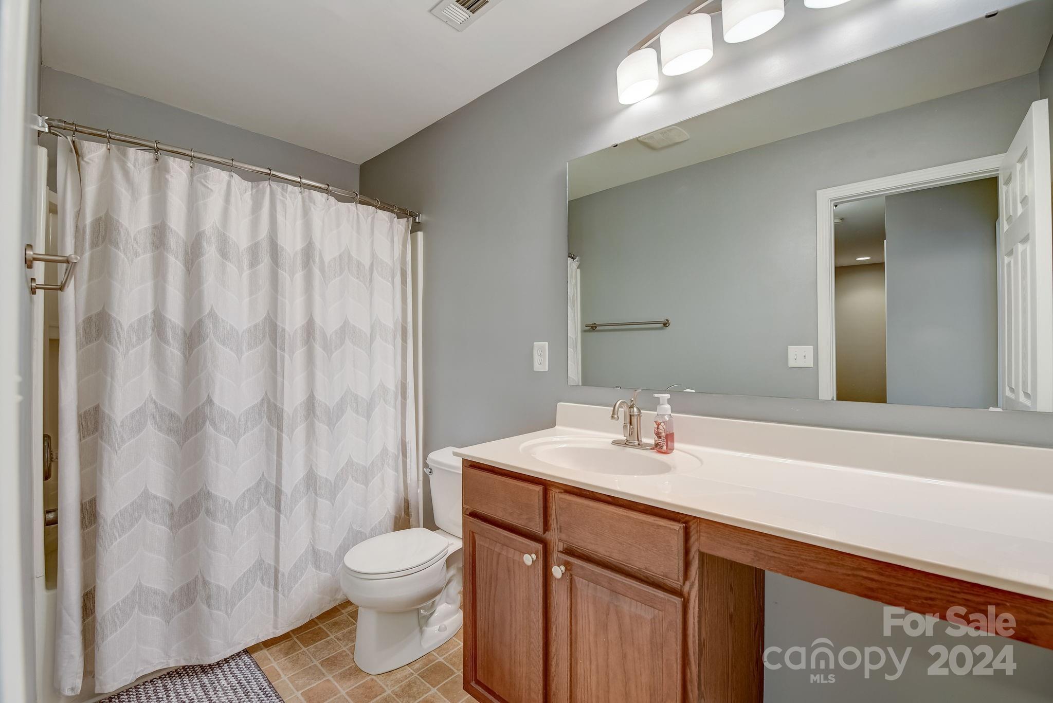 212 River Clay Road Fort Mill, SC 29708 - Photo 18 of 34 a bathroom with a sink a toilet and shower curtain