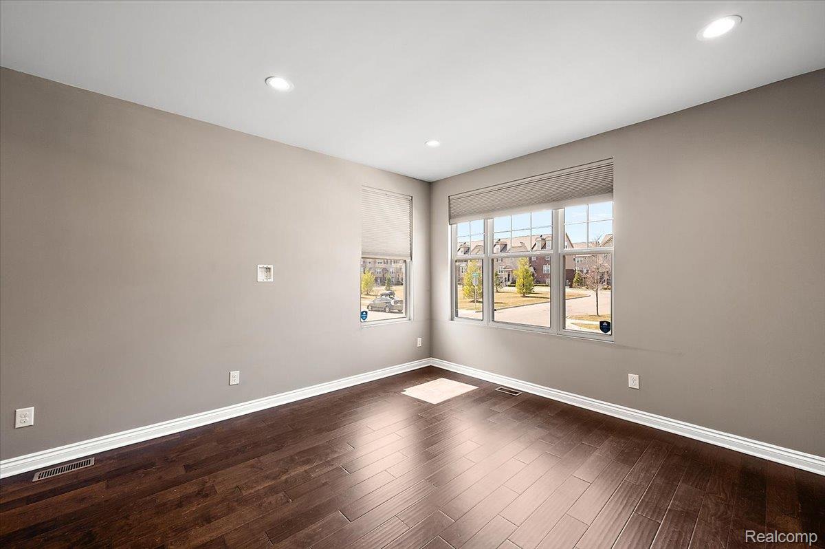 2877 Hartwick Drive Rochester, MI 48307 - Photo 13 of 44 Unfurnished room featuring dark wood-style floors and recessed lighting