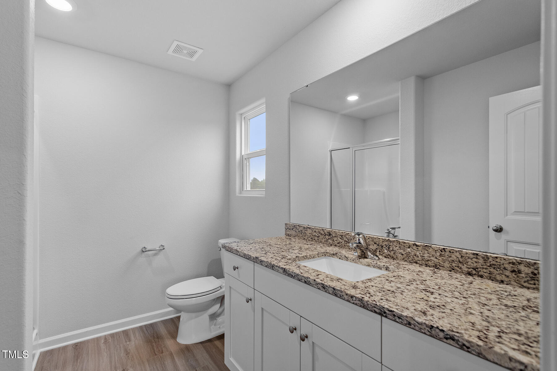 65 Crow Field Street Roxboro, NC 27574 - Photo 13 of 16 a bathroom with a granite countertop sink a toilet and a mirror